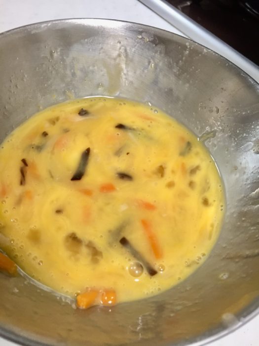 中華名菜 かに玉天心飯の具と卵を混ぜ合わせる。